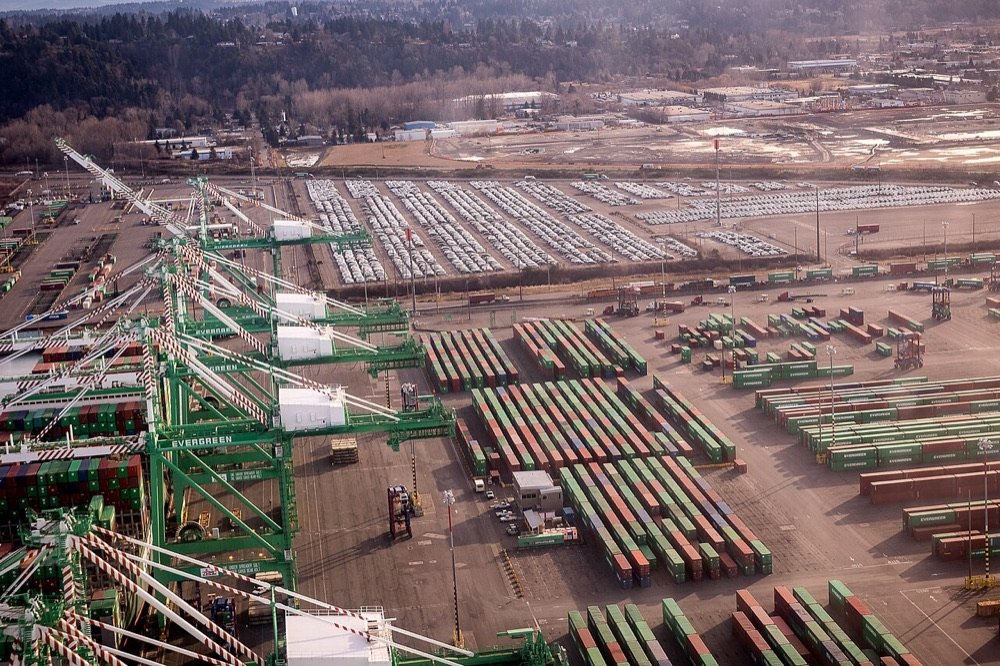 Aerial view of a container terminal with gantry cranes and stacked containers