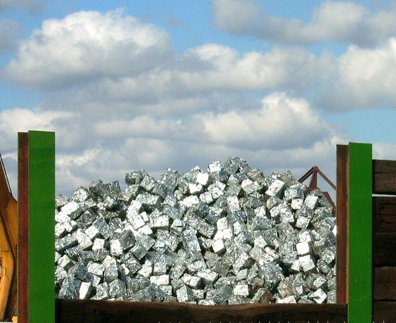 Compacted aluminum scrap briquettes in a container