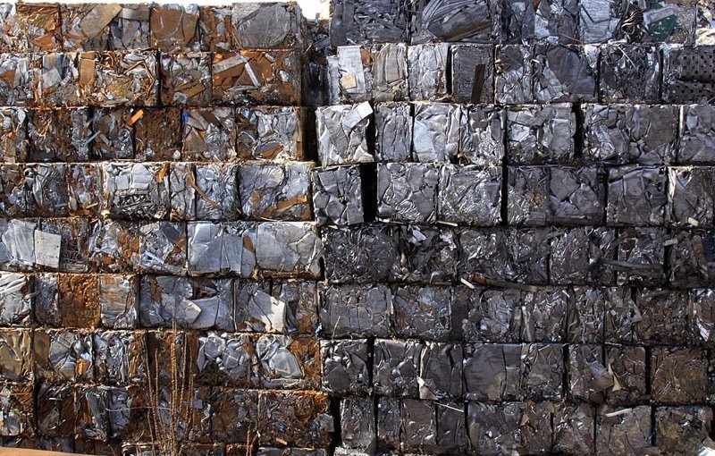 Wall of stacked scrap metal bales in the yard