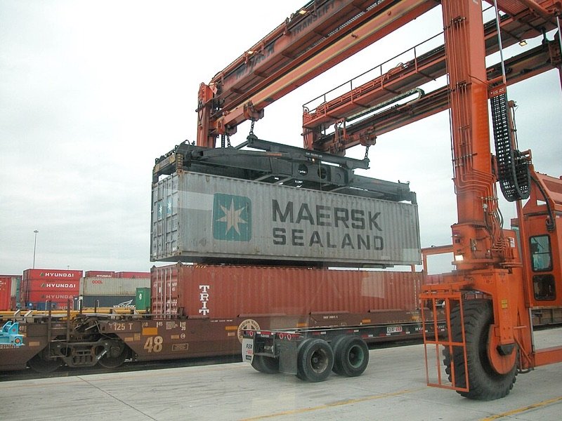 Gantry crane lifting a shipping container at an intermodal terminal