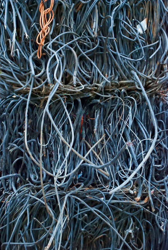 Bales of insulated copper wire awaiting recovery